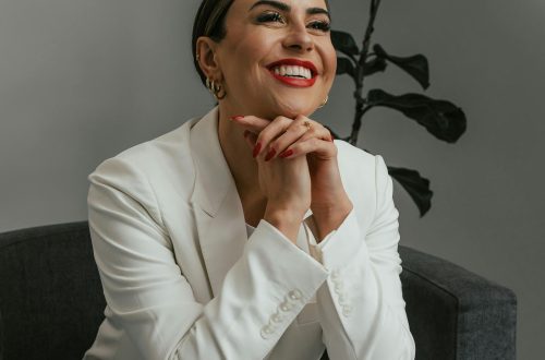 Image of woman smiling in white pant suit. Photo Courtesy of Produtora Midtrack via Pexels.com